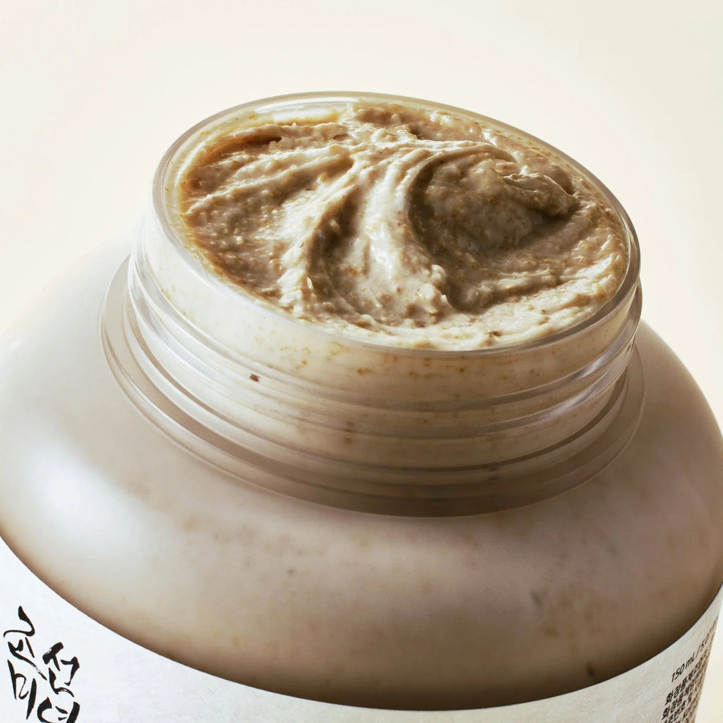 Jar of brown cream with a visible brand logo on a light background