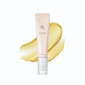 Beauty product tube with a yellow smear on a white background